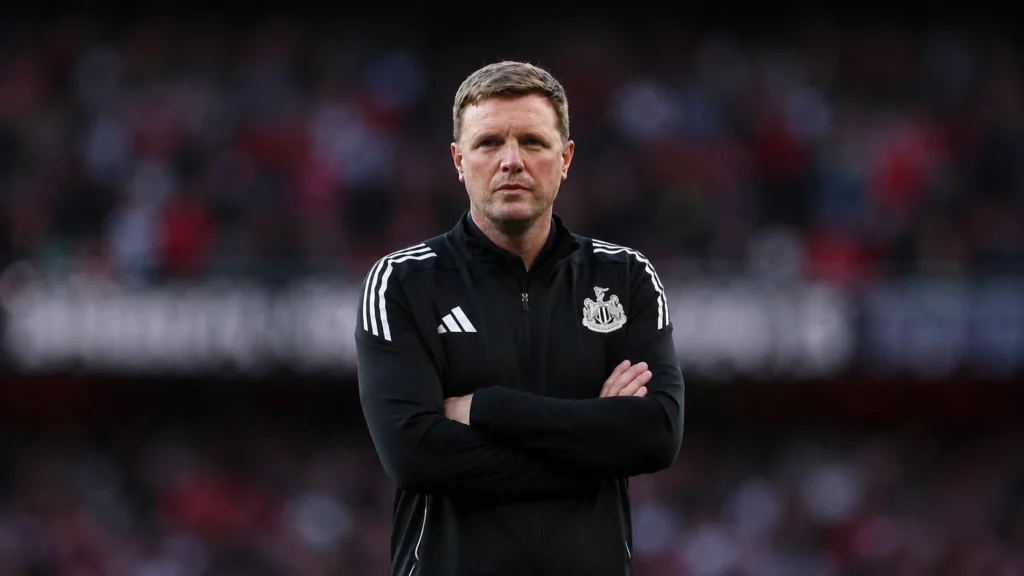 Eddie Howe stands with folded arms during a Newcastle United match before departing as manager after a successful five-year spell.