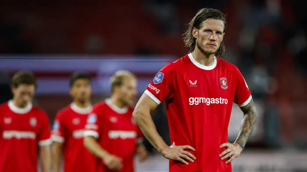 Wout Weghorst stands with hands on his waist after FC Twente's Europa League qualifying elimination against Ferencváros.