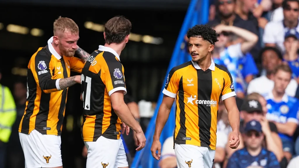 Hull City players in black and amber kits during a Premier League match at Stamford Bridge.
